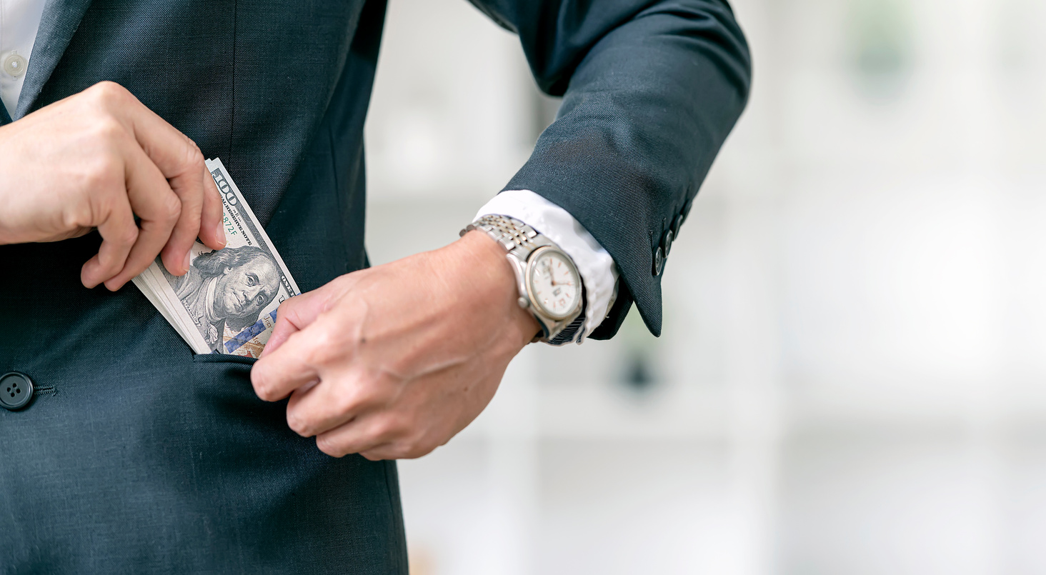 Businessman Keeping US Dollars Banknote in Suit Pocket.